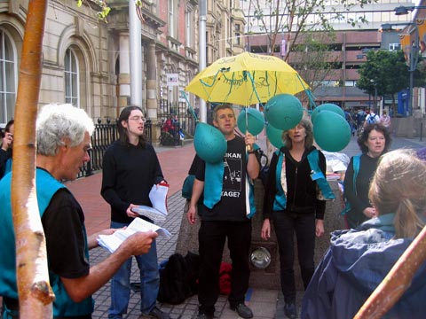 Sea Green Singers busking in the rain and wind (and some sun!)