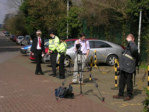 Corporate press and police officers at the demo.