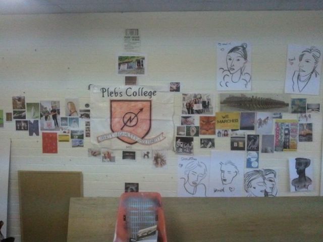The College's Coat of Arms and various useful notices on one of it's walls.